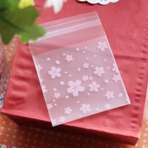 Frosted self-adhesive plastic gift packaging bags with pink cherry blossom patterns for candy.