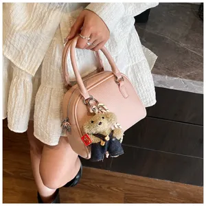Korean style pink Litchi pattern handbag with cute bear pendant, stylish crossbody shell bag.