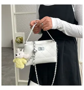 White quilted shoulder bag with chain strap and cute dog pendant, vintage chic style crossbody bag.