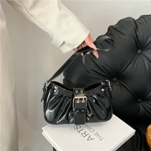 Black patent leather ruched baguette shoulder bag with stylish front buckle detail.