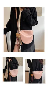 Detail view of the stylish pink saddle bag worn by model, featuring chic bear charm.