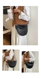 Detail shot of the black crescent shoulder bag worn by a model in casual outfit.