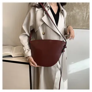 Chic burgundy saddle shoulder bag for women, minimalist solid color crossbody daily accessory.