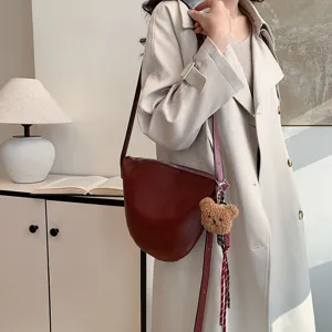 Women minimalist wine red saddle bag with plush bear charm, stylish solid color crossbody bag