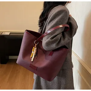 Stylish burgundy tote bag for women, large capacity minimalist shoulder bag for daily commute.