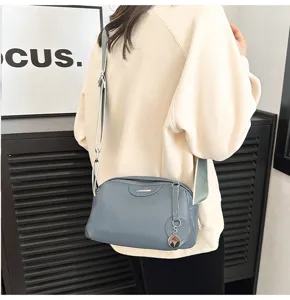 Detail view of the stylish genuine leather soft crossbody bag in blue-gray, everyday chic.