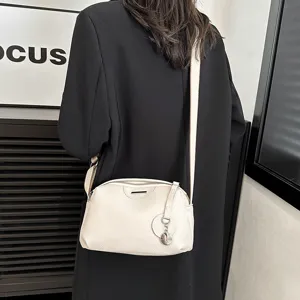 Minimalist leather crossbody bag for women, soft shoulder purse with metal accent.