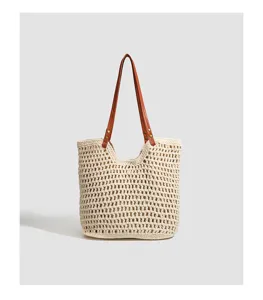 Detailed view of the woven straw tote bag texture, showing intricate crochet craftsmanship.