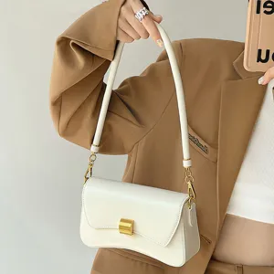 Minimalist white leather baguette bag for women, stylish underarm shoulder bag with metal lock.