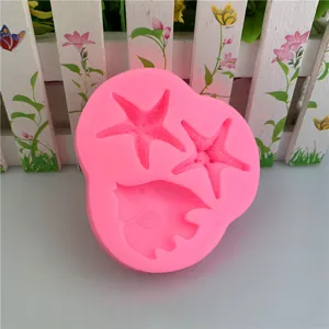 Detailed view of a pink silicone mold featuring starfish and fish shapes for baking and crafts.