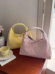 Detail view of Korean style casual women crossbody shoulder bag with sweet bow knot design.