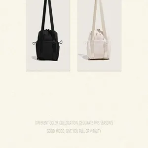 Minimalist nylon shoulder bag detail showing dual color options, compact design, and straps.