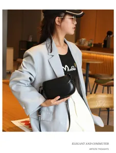 Minimalist black leather saddle bag for women, stylish crossbody handbag for daily commuter use.