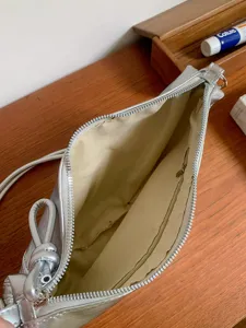 Silver shoulder bag for women, trendy underarm bag with zipper closure and inner pocket.