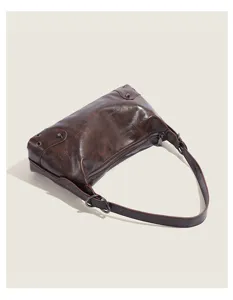 Vintage dark brown shoulder bag detail, distressed leather with stylish metal hardware.