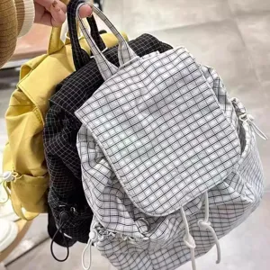 Detail shot showcasing multiple color variants of casual plaid drawstring backpacks, nylon.