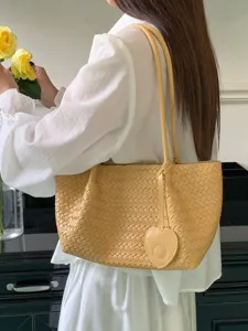 Buttery yellow woven leather shoulder tote bag with heart pendant for women elegant daily use