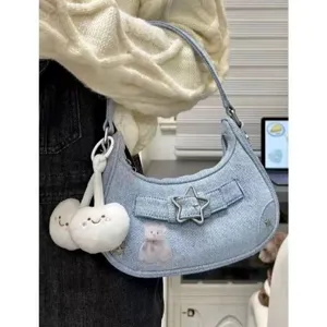 Detailed view of the retro denim shoulder bag with star buckle and cute plush charm.