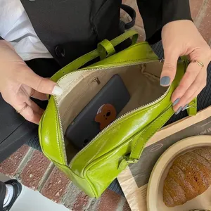 Green patent leather underarm shoulder bag interior view showing large capacity design.