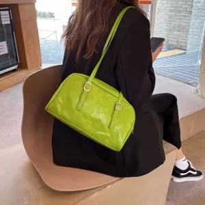 Green leather shoulder bag for women, casual underarm handbag with chic double buckle straps.