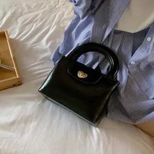 Black heart lock handbag with round handle, stylish PU leather top handle bag for daily wear.
