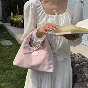 Chic Korean pink women shoulder bag with sweet bow detail, elegant daily handbag accessory.