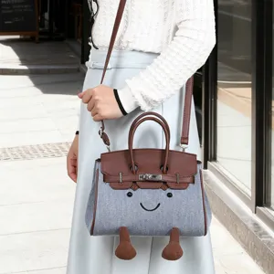 Cute denim smiley face handbag shoulder crossbody bag with top handle and cute cartoon design.