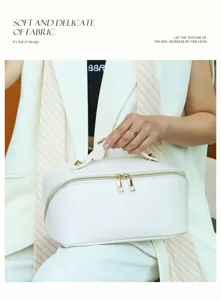 Detailed view of white leather cosmetic bag, portable travel makeup storage pouch.
