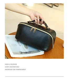 Black leather cosmetic bag with gold zipper and top handle for travel and daily use