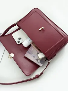 Red minimalist structured shoulder bag with metal lock closure for women daily commute style