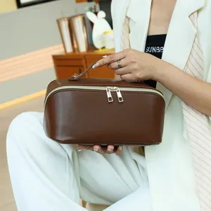 Brown PU leather cosmetic bag, large capacity portable travel toiletry storage pouch.