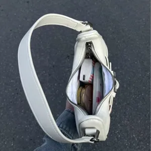 White retro baguette shoulder bag for women, minimalist underarm handbag with chic strap.