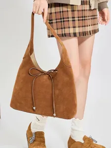 Braune Wildleder Hobo Schultertasche für Damen mit filigraner Schleife und großem Stauraum.
