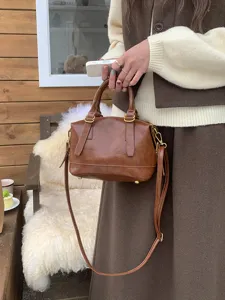 Vintage brown PU leather bowling shoulder bag, stylish casual handbag for women daily commute.