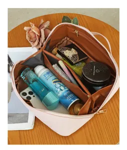 Detailed view of open pink cosmetic travel bag showcasing large capacity and neat storage.