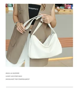 White slouchy shoulder bag with wide strap, versatile casual tote for daily commuting.