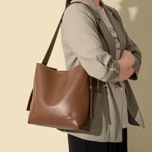 Stylish brown PU leather bucket bag for women, large capacity soft shoulder tote handbag.