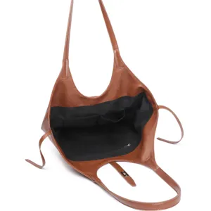 Interior detail view of brown leather tote bag showing large capacity and multi-pocket design.