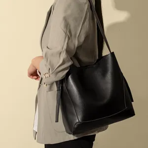 Black PU leather bucket bag for women, large capacity stylish shoulder tote bag for daily commute.