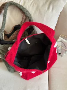 Detailed view of the cozy plush tote bag with soft furry texture and dark interior lining.