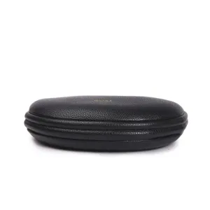 Black leather structured hard case bag, compact minimalist design with chic gold logo.