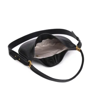 Black leather hobo bag detail view showing interior lining, zipper pocket and gold hardware.