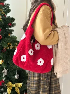 Red plush shoulder bag detail showing cute white floral embroidery and cozy winter style.