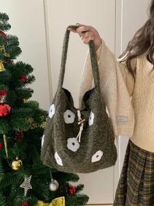 Detailed view of the dark green fuzzy tote bag with cute white floral embroidery and cozy style.