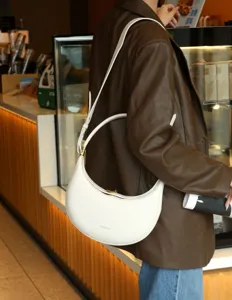 White crescent hobo bag for women, stylish leather shoulder crossbody bag, casual commuter handbag.