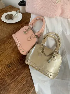 Patent leather rivet shell handbag detail showcasing exquisite hardware and chic design.