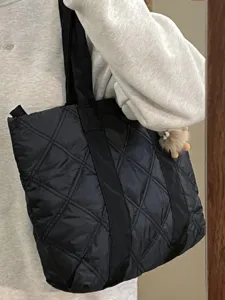 Black quilted puffer tote bag detail, featuring soft down-like material and large capacity design.