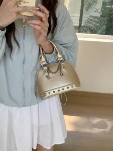 Champagne gold metallic dome handbag with chic studs and chain charm for women stylish daily use.