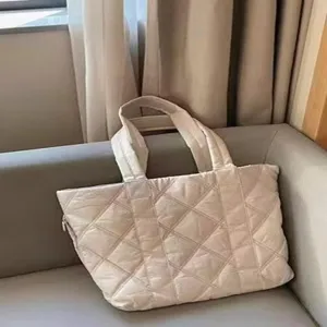 Close-up of a stylish quilted down puffer tote bag with large capacity, ideal for daily commute.