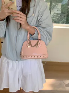 Pink patent leather dome handbag with studs and chain detail, stylish women's shoulder bag
